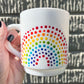 Person holding Vintage-style Rainbow Dot textured Teacup in direct sunlight in front of concrete wall. Made by Camille Gerrick.