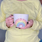 Person holding a Porcelain Colorful Short Latte Mug with hand-painted dotted ROYGBIV rainbow by Camille Gerrick 