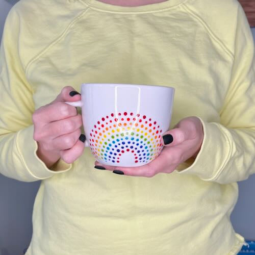 Person holding a Porcelain Colorful Short Latte Mug with hand-painted dotted ROYGBIV rainbow by Camille Gerrick 