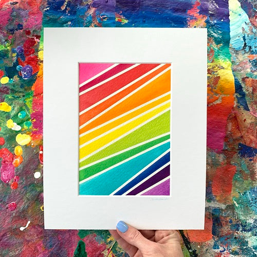 Example of more rainbow tape art featuring diagonal stripes rainbow colors broken up by lines of white by Camille Gerrick